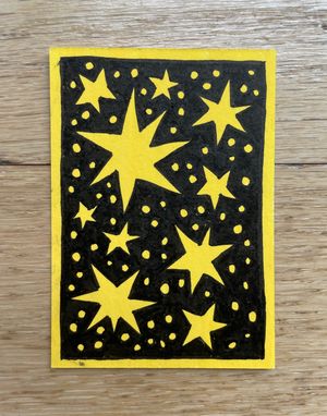 A small artwork of yellow star shapes against a black background, with a yellow border. The star shapes are many-pointed and a little wonky, and the space in between them is filled in with small yellow dots.