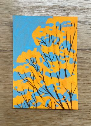 A small artwork of bright yellow foliage against a blue sky, with dark tree branches connecting the abstract shapes of leaves.