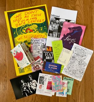 A spread of comics, zines, and other A2CAF acquisitions.