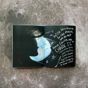 Open spread of the zine, featuring a photo of astronaut Christina Koch looking out the spacecraft window at the Earth. Written over the photo is her quote 'With this burn to the moon, we do not leave Earth, we choose it,' from just before the trans-lunar injection burn that committed Integrity to lunar orbit.